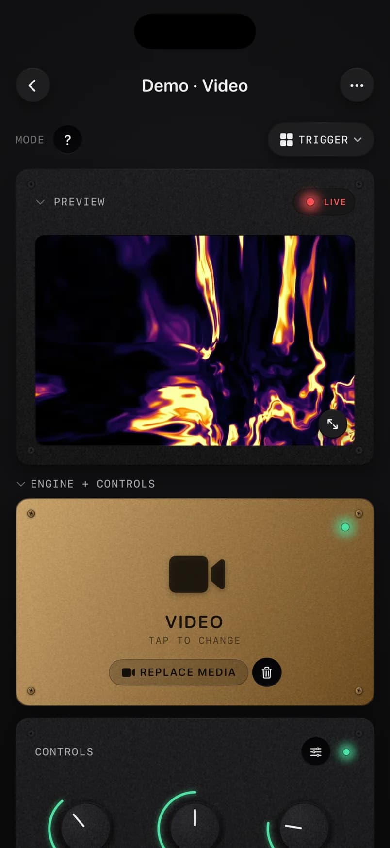 ImmerGround on iPhone: a fiery inferno clip in the live preview, above the brass Video engine tile and the controls